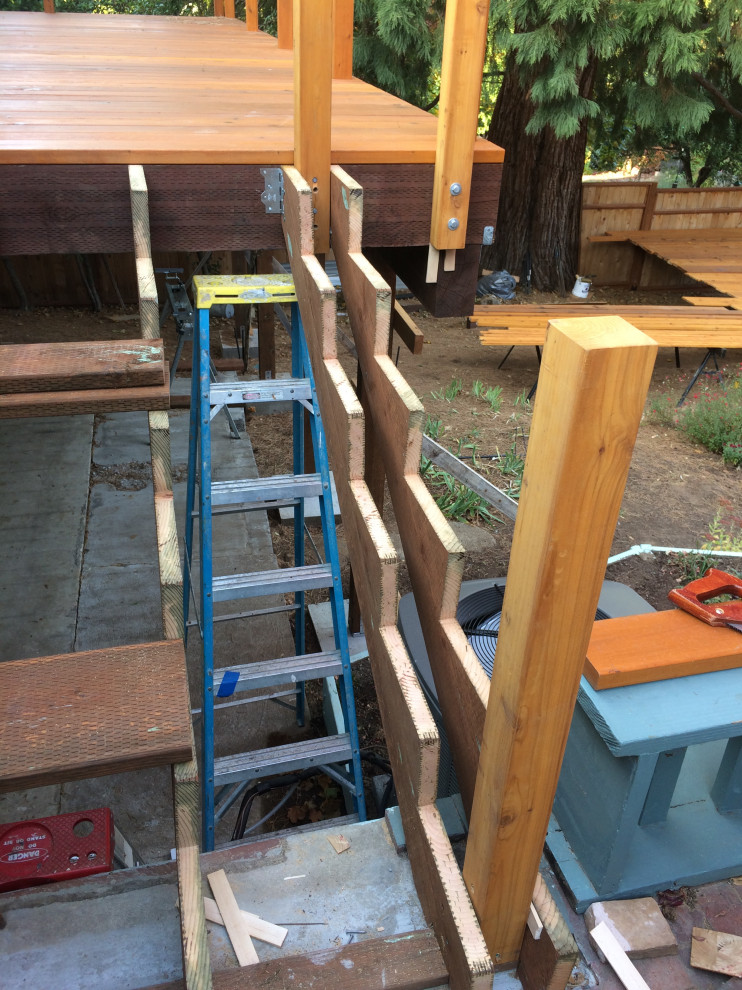 Deck - small backyard second story wood railing deck idea with no cover