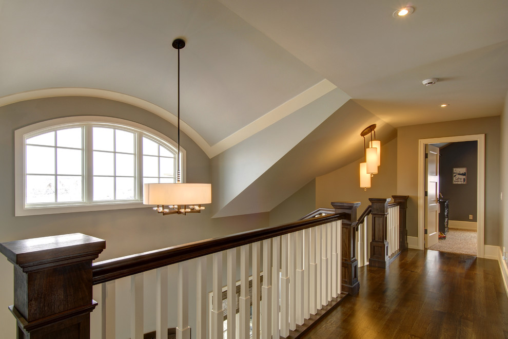 This is an example of a traditional hallway in Calgary with grey walls and medium hardwood floors.
