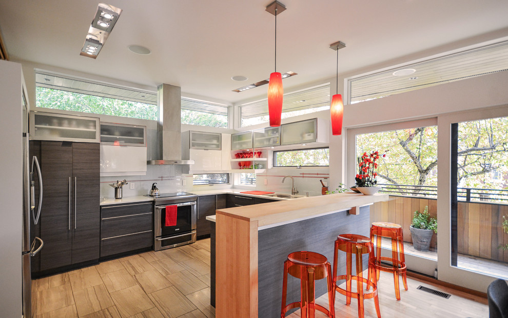 Mid-sized contemporary u-shaped separate kitchen in Toronto with flat-panel cabinets, stainless steel appliances, a peninsula, a double-bowl sink, dark wood cabinets, solid surface benchtops, window splashback and porcelain floors.