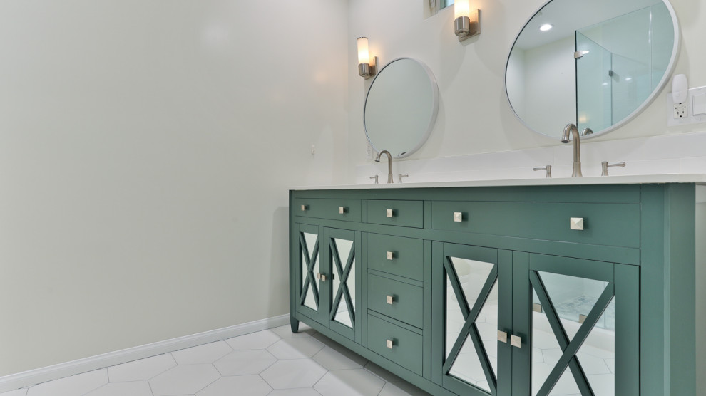Photo of a mid-sized modern master bathroom in Los Angeles with shaker cabinets, green cabinets, a corner shower, a one-piece toilet, white tile, ceramic tile, beige walls, mosaic tile floors, a drop-in sink, marble benchtops, white floor, a hinged shower door, white benchtops, a single vanity, a built-in vanity and decorative wall panelling.