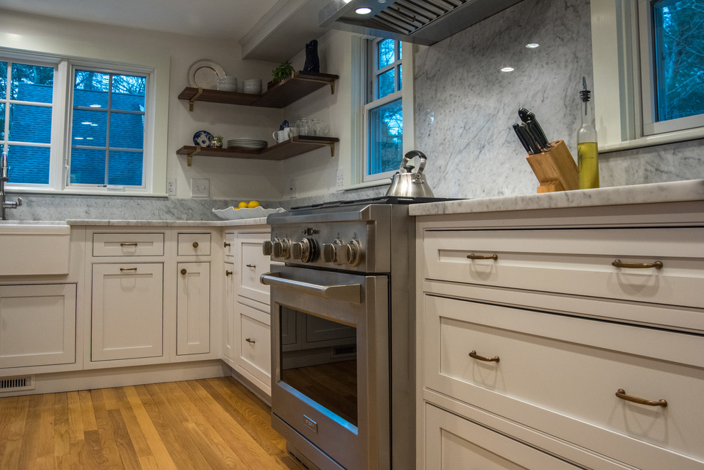 Inspiration for a country u-shaped kitchen in Boston with a farmhouse sink, beaded inset cabinets, white cabinets, marble benchtops, marble splashback and with island.