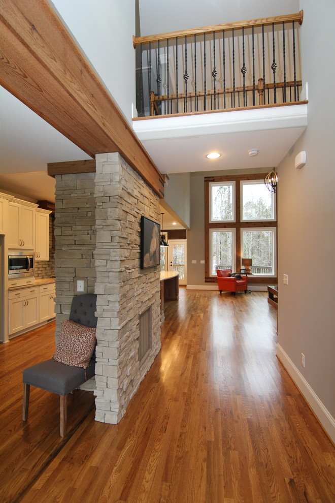 Inspiration for a large transitional medium tone wood floor foyer remodel in Raleigh with gray walls and a dark wood front door