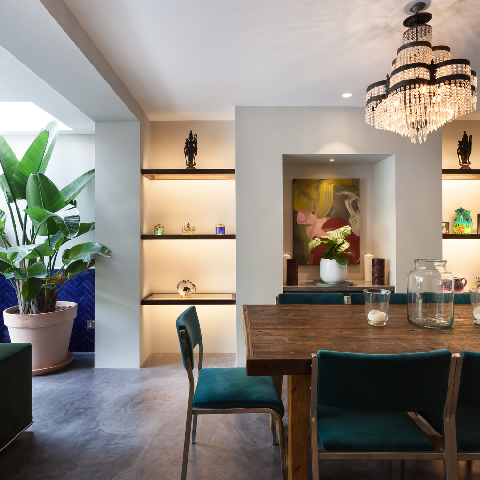 Mid-sized contemporary dining room in London with concrete floors, grey floor and grey walls.