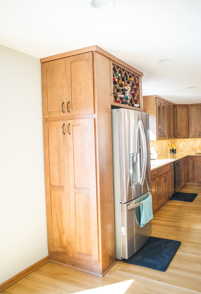 Large transitional l-shaped dark wood floor open concept kitchen photo with an undermount sink, recessed-panel cabinets, medium tone wood cabinets, quartz countertops, beige backsplash, stainless steel appliances and an island