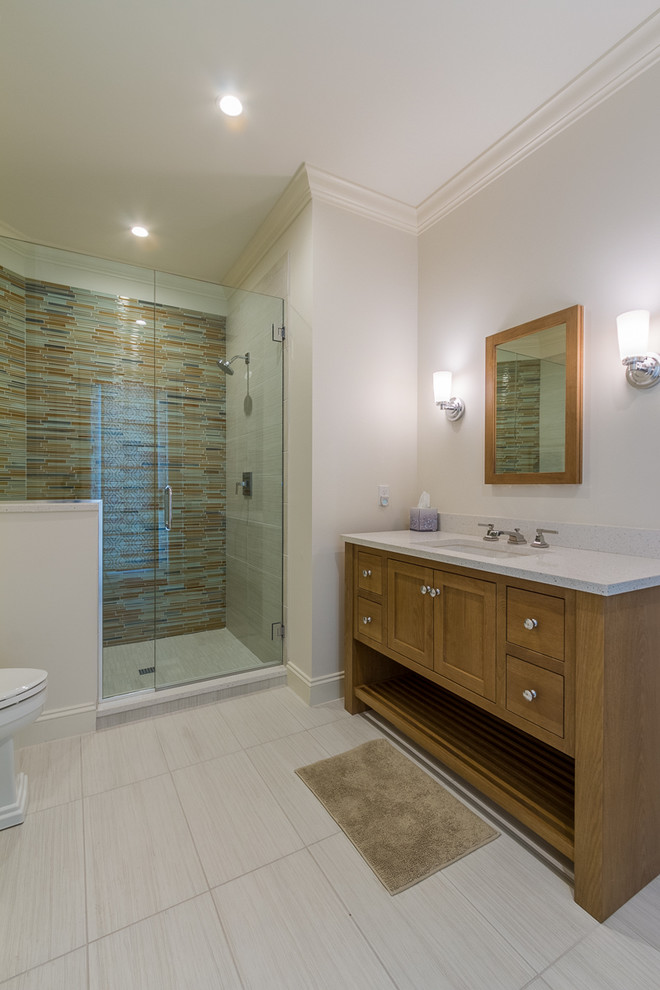 Photo of a mid-sized beach style kids bathroom in Tampa with beaded inset cabinets and light wood cabinets.