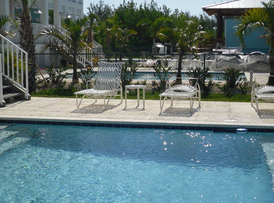 Inspiration for a backyard tile and rectangular hot tub remodel in Miami