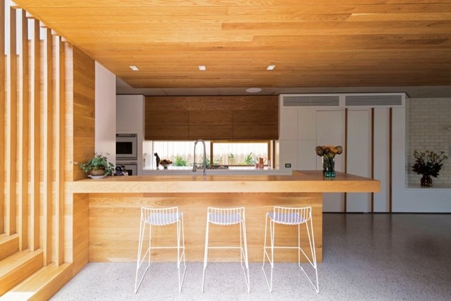 Photo of a mid-sized contemporary eat-in kitchen in Sydney with concrete floors and with island.