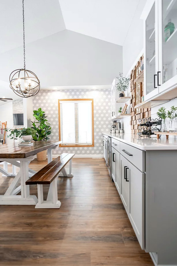 This is an example of a large scandinavian kitchen/dining combo in Minneapolis with grey walls, medium hardwood floors, brown floor and planked wall panelling.