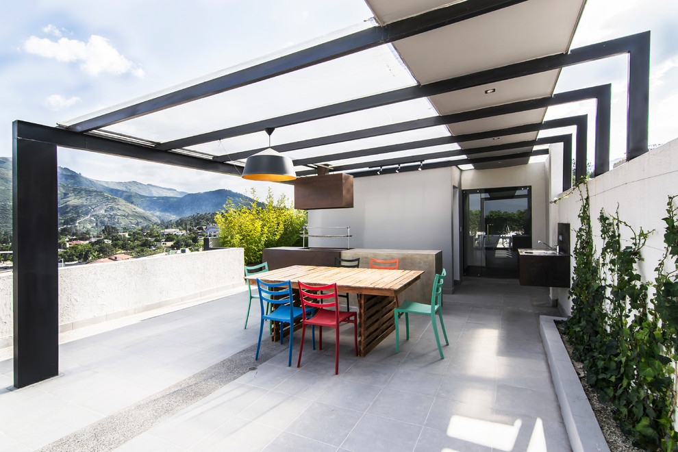 Photo of a contemporary rooftop and rooftop deck in Other with an outdoor kitchen and a pergola.
