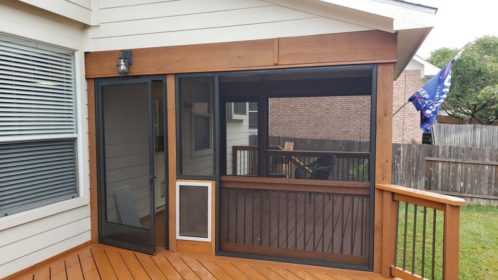 Inspiration for a large country backyard screened-in verandah in Austin with a roof extension and mixed railing.