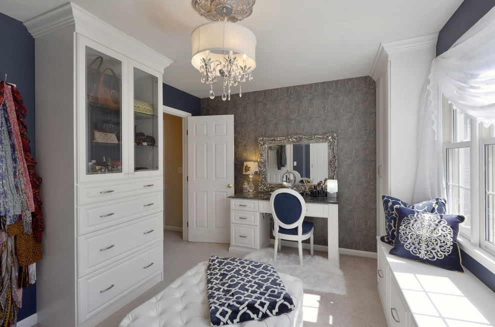 Large contemporary gender-neutral walk-in wardrobe in New York with raised-panel cabinets, white cabinets and carpet.