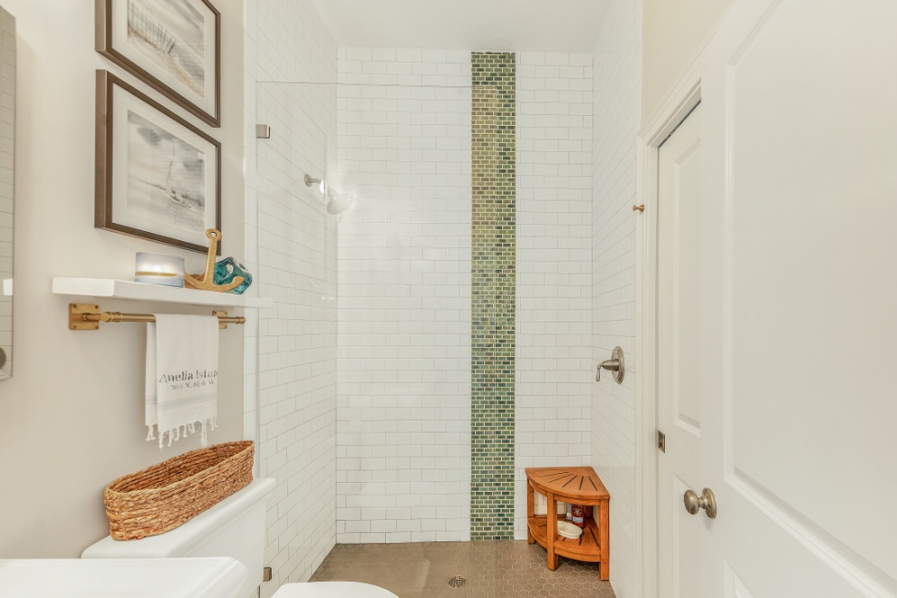 Inspiration for a mid-sized beach style 3/4 bathroom with an alcove shower, a two-piece toilet, green tile, white tile, subway tile, grey walls, dark hardwood floors, a pedestal sink, brown floor and an open shower.