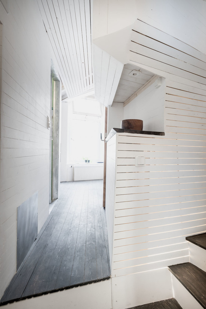 Mid-sized contemporary hallway in Gothenburg with white walls and dark hardwood floors.