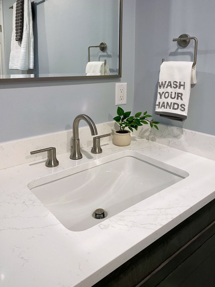 Transitional white tile and ceramic tile porcelain tile, gray floor and single-sink corner shower photo in Boston with shaker cabinets, gray cabinets, a one-piece toilet, gray walls, an undermount sink, quartz countertops, a hinged shower door, white countertops and a built-in vanity