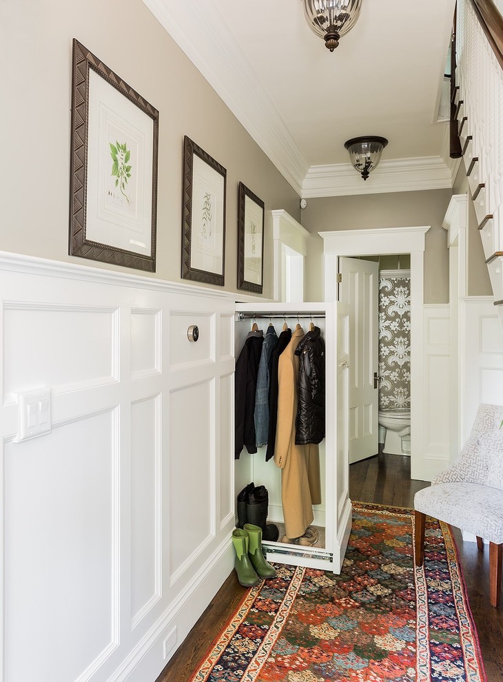 Example of a classic mudroom design in Boston with beige walls