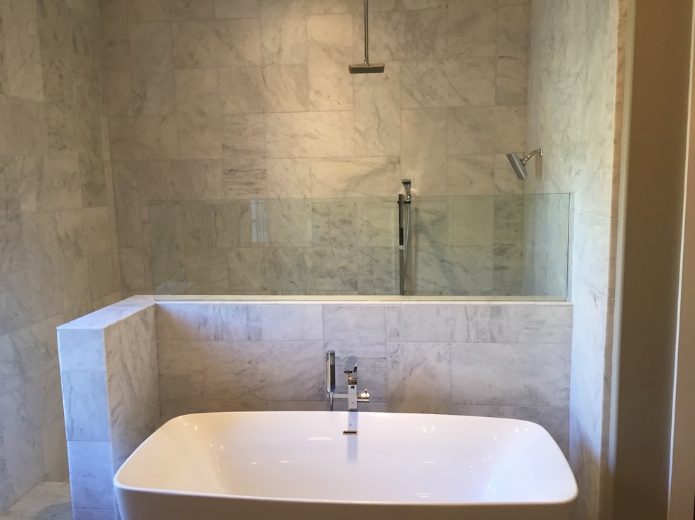 Inspiration for a mid-sized transitional master bathroom in Birmingham with an undermount sink, shaker cabinets, white cabinets, marble benchtops, a freestanding tub, an open shower, a two-piece toilet, white tile, stone tile, grey walls and ceramic floors.