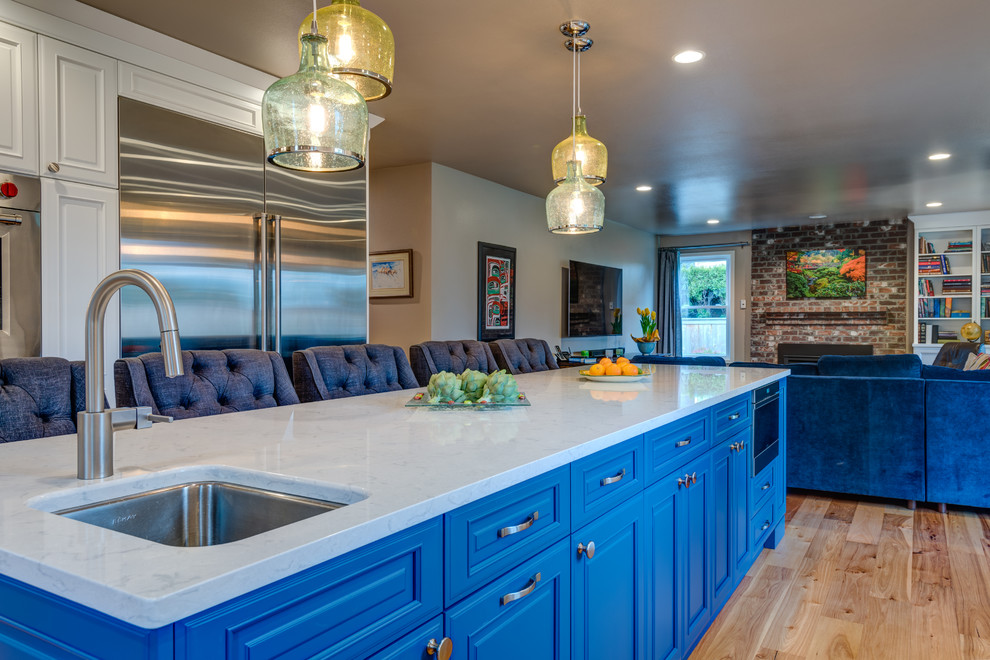 Eat-in kitchen - large transitional u-shaped light wood floor eat-in kitchen idea in Seattle with an undermount sink, beaded inset cabinets, blue cabinets, quartz countertops, multicolored backsplash, porcelain backsplash, stainless steel appliances and an island