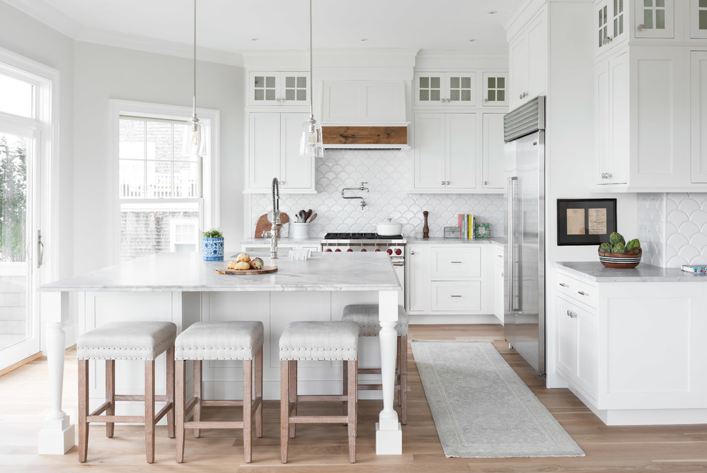 Inspiration for a large transitional l-shaped medium tone wood floor and brown floor open concept kitchen remodel with quartzite countertops, an island, a double-bowl sink, shaker cabinets, white cabinets, white backsplash, stainless steel appliances and gray countertops
