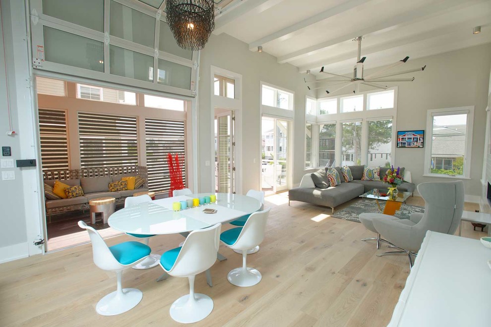 Photo of a mid-sized beach style open plan dining in Other with grey walls, no fireplace and light hardwood floors.