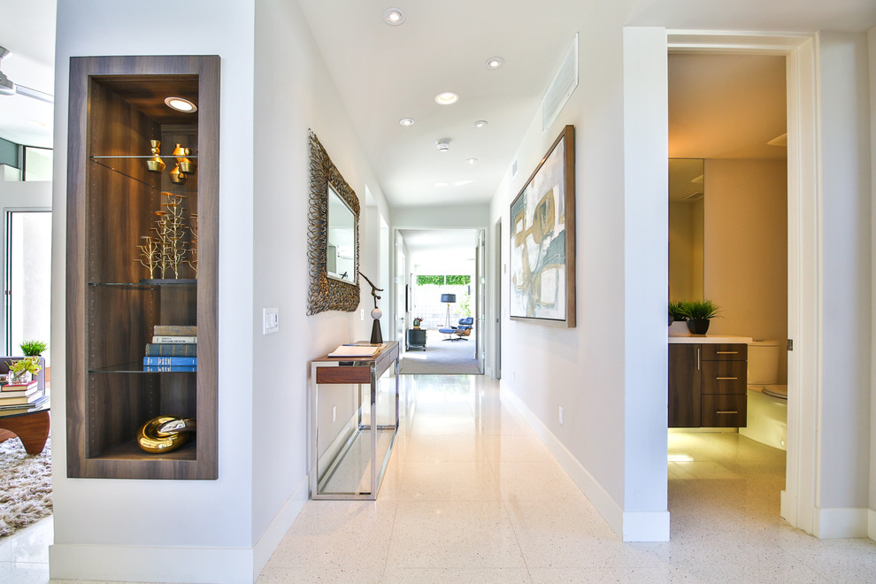 This is an example of a large modern hallway in Other with white walls.