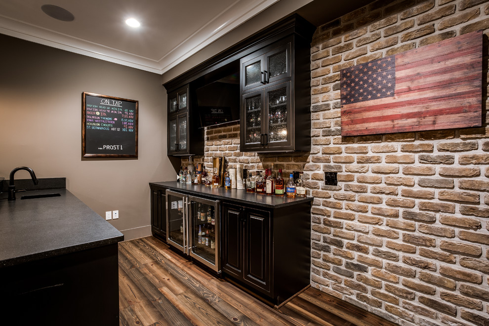 Inspiration for a large arts and crafts galley wet bar in DC Metro with a drop-in sink, glass-front cabinets, dark wood cabinets, wood benchtops, red splashback, stone tile splashback and medium hardwood floors.