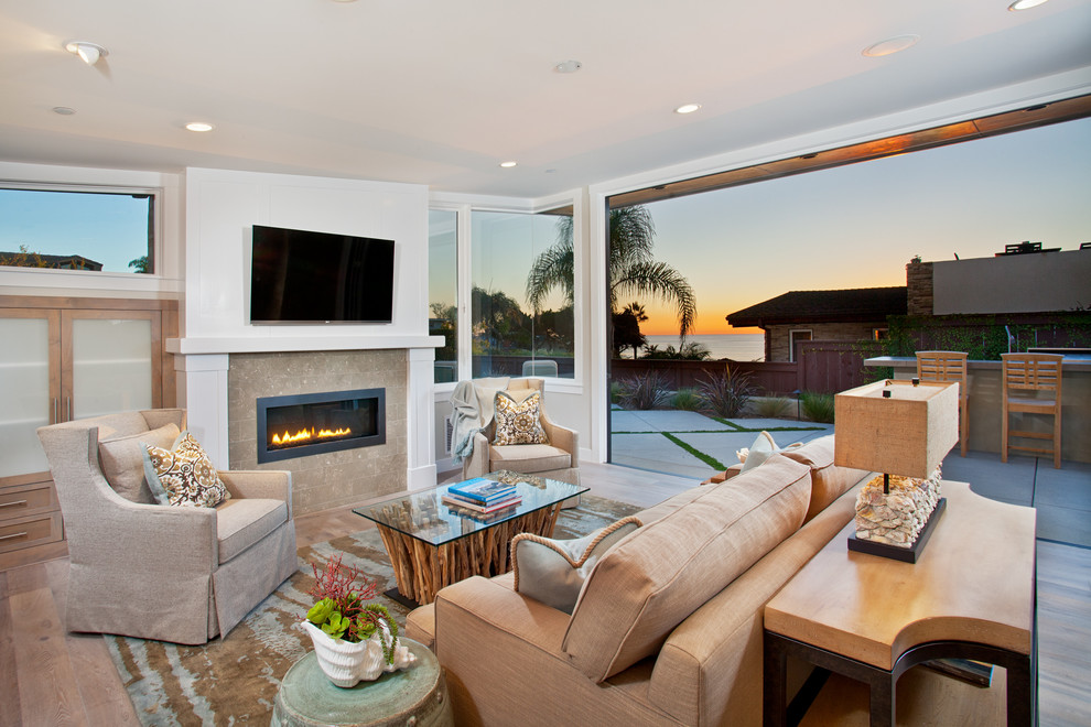 Design ideas for a contemporary open concept family room in San Diego with white walls, a ribbon fireplace and a wall-mounted tv.