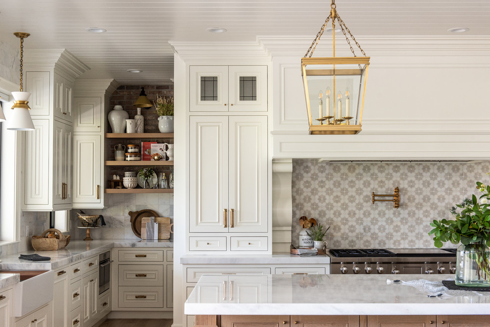 Design ideas for a transitional u-shaped open plan kitchen in Salt Lake City with white cabinets and with island.