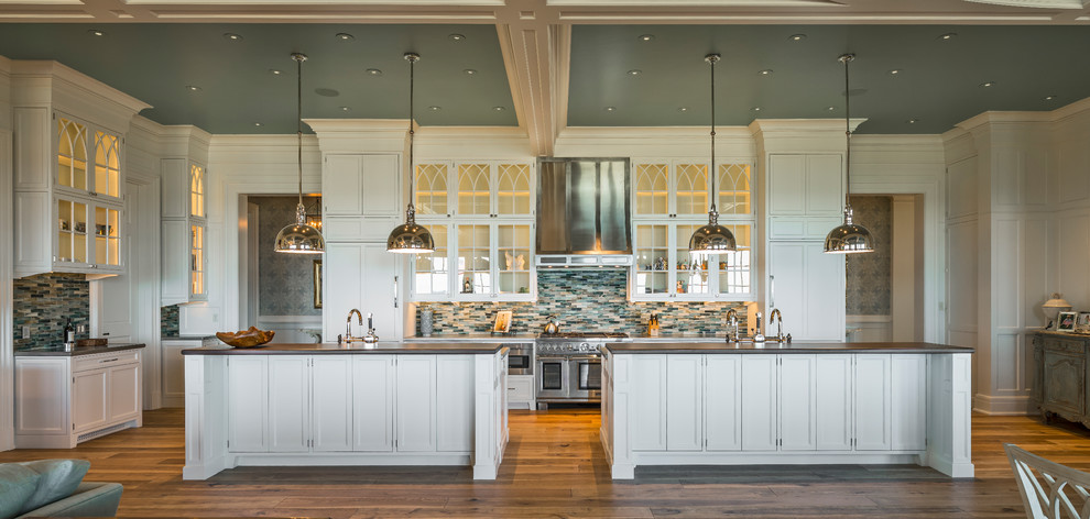 Photo of an expansive traditional u-shaped eat-in kitchen in Providence with recessed-panel cabinets, yellow cabinets, marble benchtops and multiple islands.