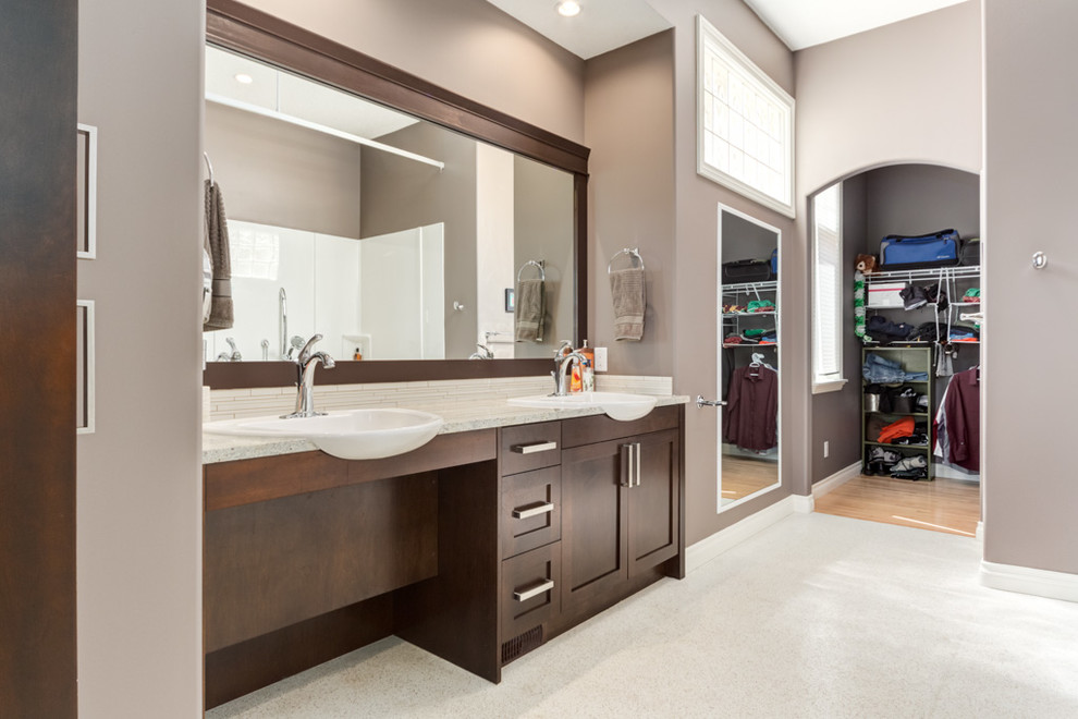 This is an example of a large transitional master bathroom in Calgary with a vessel sink, shaker cabinets, dark wood cabinets, engineered quartz benchtops, a curbless shower, a two-piece toilet, white tile, porcelain tile, beige walls and linoleum floors.