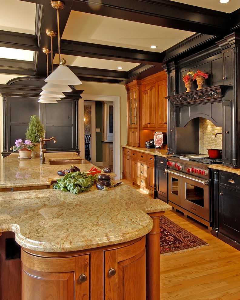 Inspiration for a large traditional l-shaped separate kitchen in Philadelphia with a farmhouse sink, shaker cabinets, black cabinets, granite benchtops, beige splashback, stone tile splashback, panelled appliances, light hardwood floors and with island.