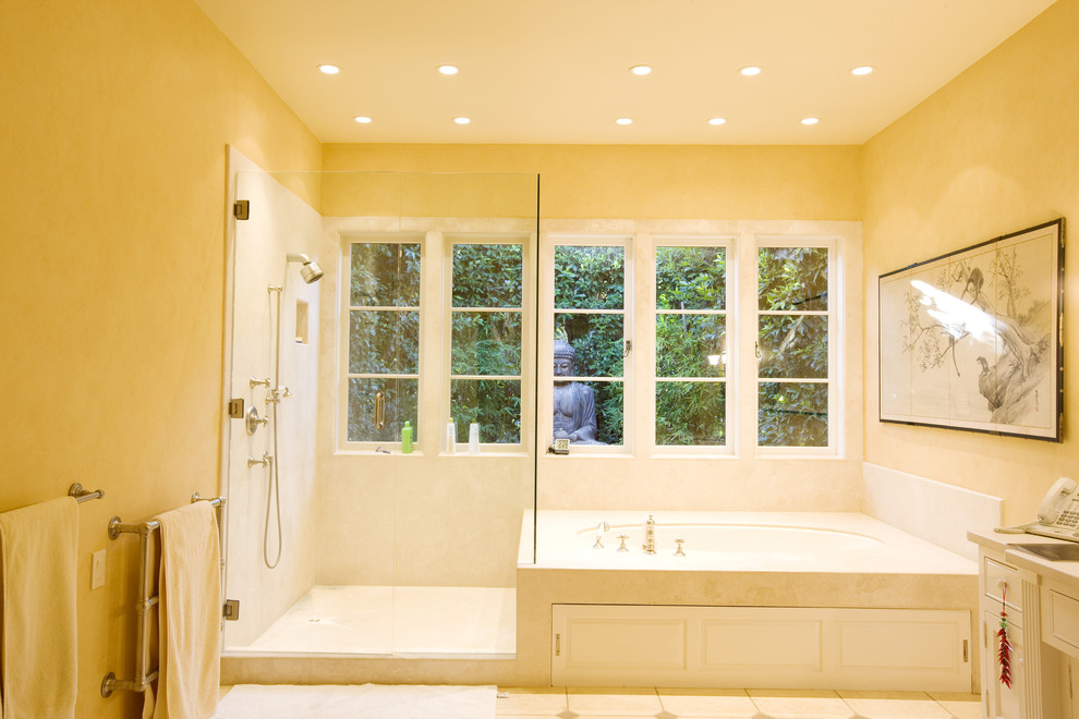 Large mediterranean master bathroom in Santa Barbara with yellow walls, recessed-panel cabinets, white cabinets, an alcove tub, an alcove shower and an undermount sink.