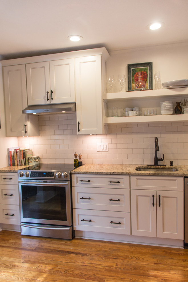 Kitchen - transitional medium tone wood floor kitchen idea with granite countertops, subway tile backsplash and stainless steel appliances