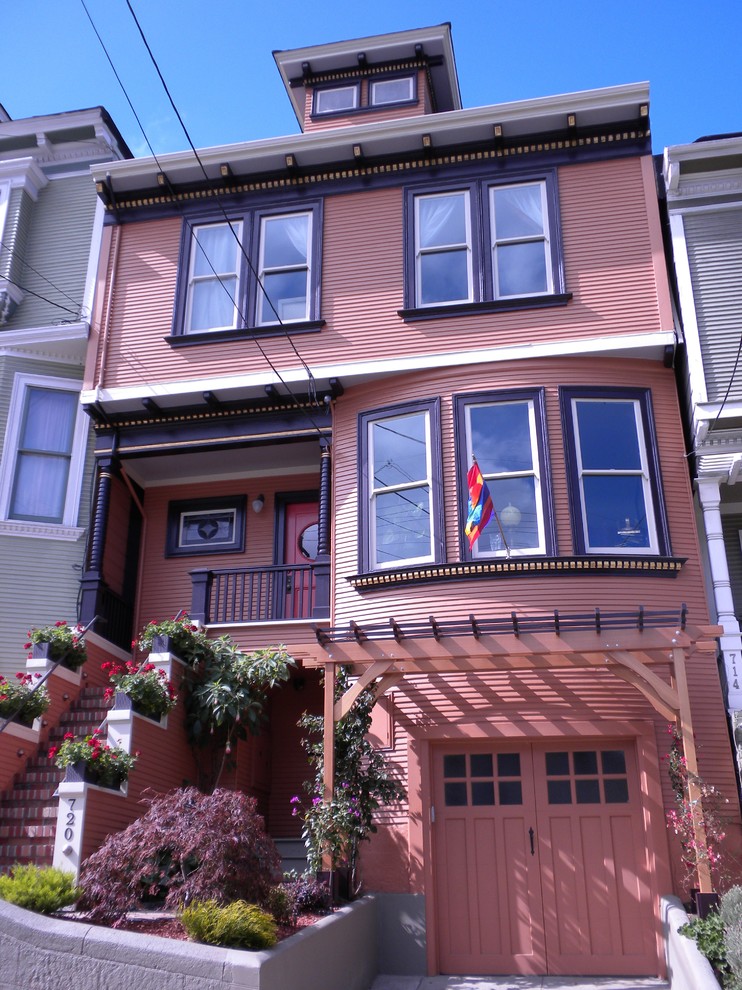 Large traditional three-storey brown exterior in San Francisco with vinyl siding and a flat roof.
