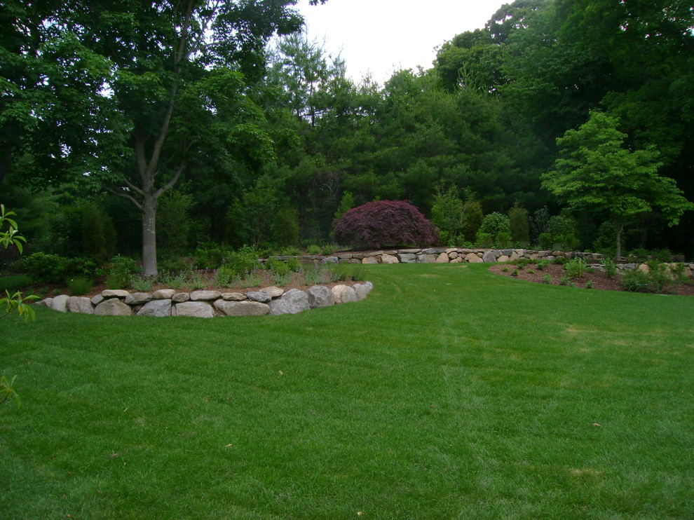 Photo of a mid-sized traditional backyard partial sun formal garden in Other.