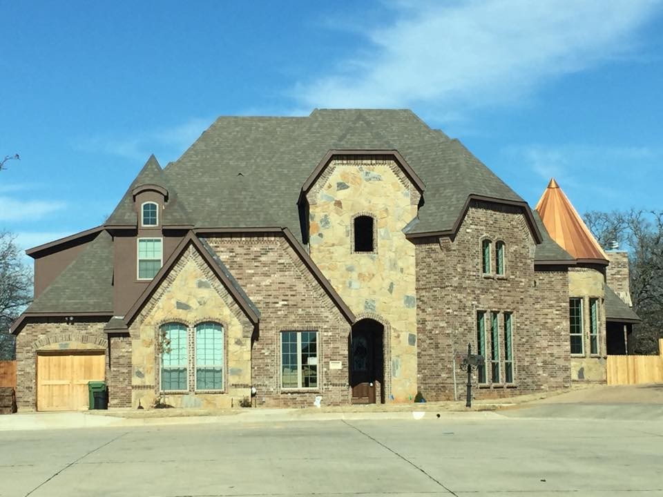 Inspiration for an expansive traditional three-storey beige exterior in Dallas with a hip roof and stone veneer.