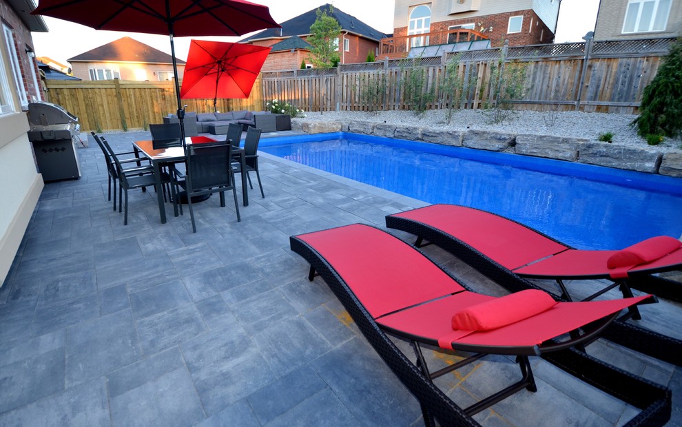 Pool - mid-sized transitional backyard concrete paver and rectangular lap pool idea in Toronto