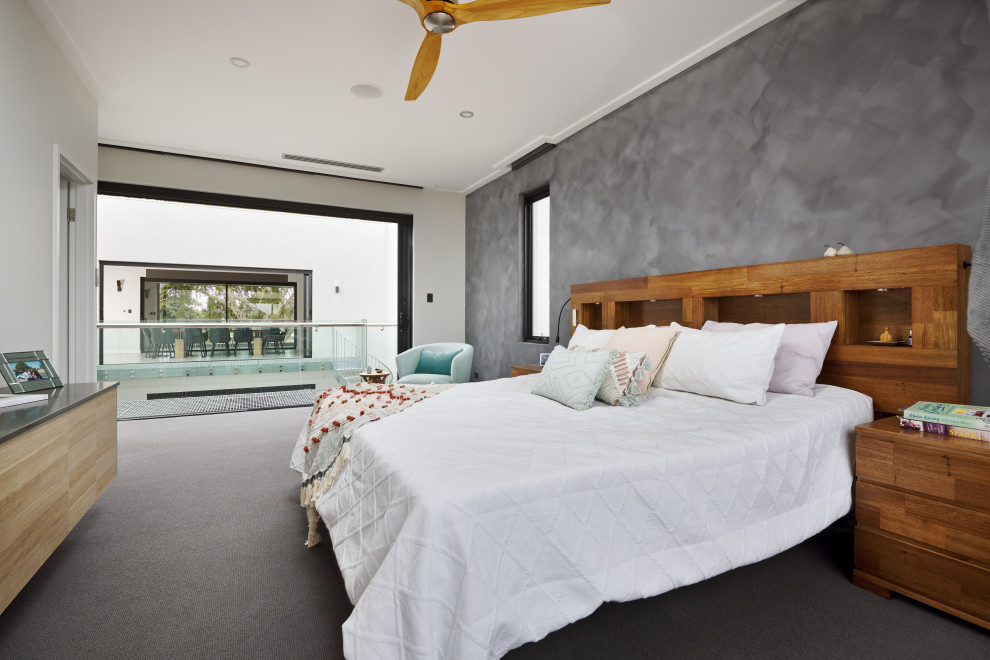 Large modern master bedroom in Perth with grey walls, carpet and grey floor.