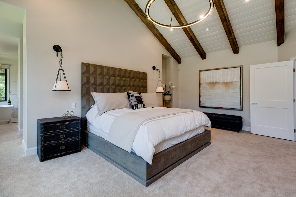 Inspiration for a large modern master bedroom in Los Angeles with beige walls, carpet, a standard fireplace, a wood fireplace surround and beige floor.