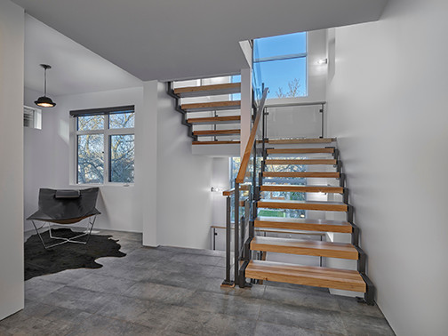 Inspiration for a mid-sized contemporary wood straight staircase in Edmonton with open risers and mixed railing.