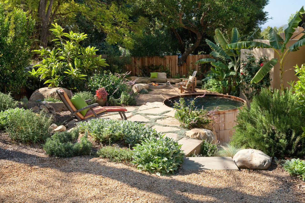 Photo of a country backyard patio in Santa Barbara with a fire feature and natural stone pavers.