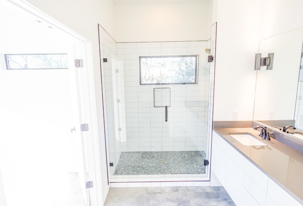 Inspiration for a small modern master bathroom in Austin with flat-panel cabinets, white cabinets, white tile, subway tile and engineered quartz benchtops.