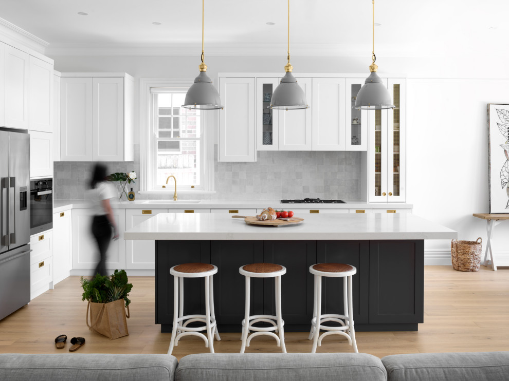 Inspiration for a large transitional l-shaped open plan kitchen in Sydney with an undermount sink, shaker cabinets, grey cabinets, quartz benchtops, grey splashback, ceramic splashback, stainless steel appliances, light hardwood floors, with island, beige floor and yellow benchtop.