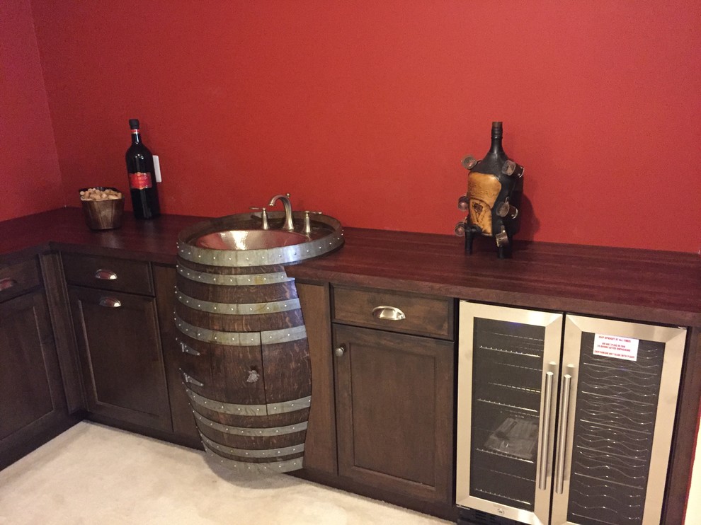 Inspiration for a country l-shaped home bar in Baltimore with recessed-panel cabinets, dark wood cabinets and wood benchtops.