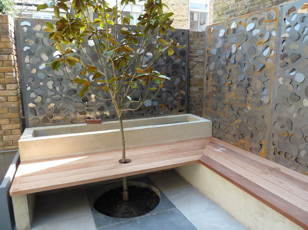 Design ideas for a small modern front yard partial sun garden in London.