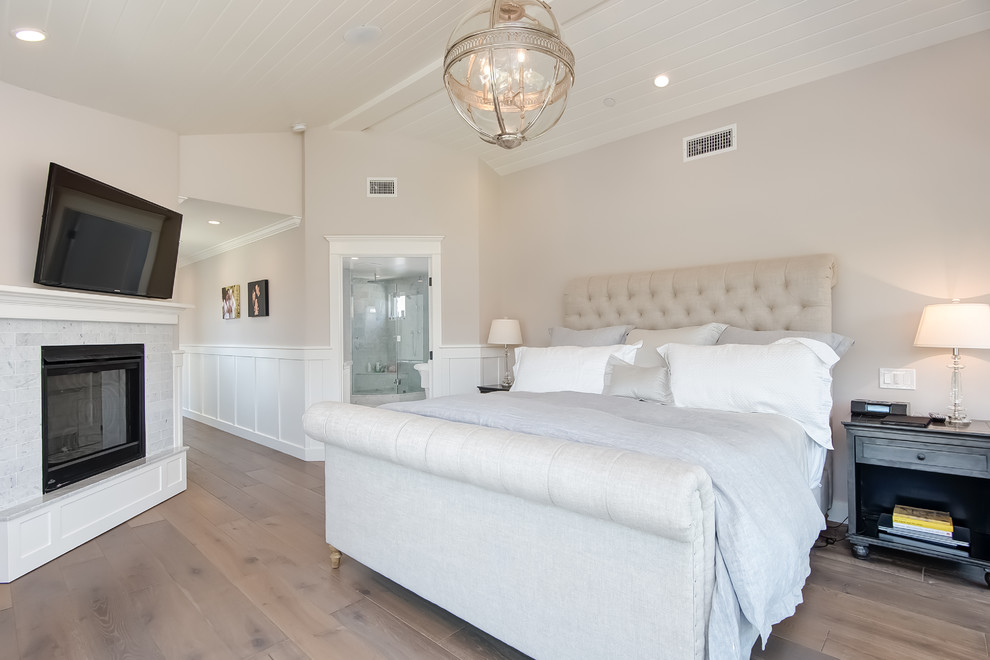 Mid-sized beach style master bedroom in Orange County with light hardwood floors.