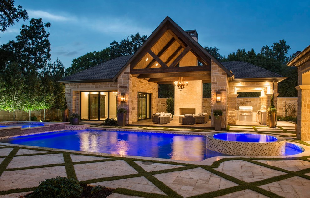 Photo of a large contemporary backyard custom-shaped pool in Dallas with a pool house and natural stone pavers.
