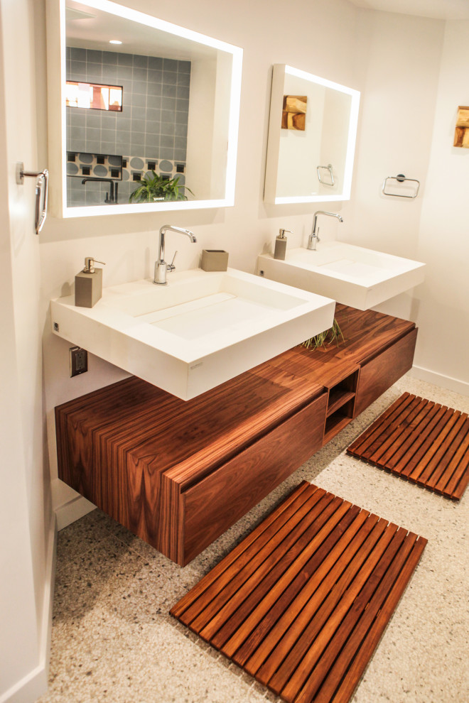 Inspiration for a mid-sized modern master bathroom in Los Angeles with open cabinets, brown cabinets, a freestanding tub, a curbless shower, a one-piece toilet, blue tile, subway tile, white walls, terrazzo floors, a wall-mount sink, yellow floor and an open shower.