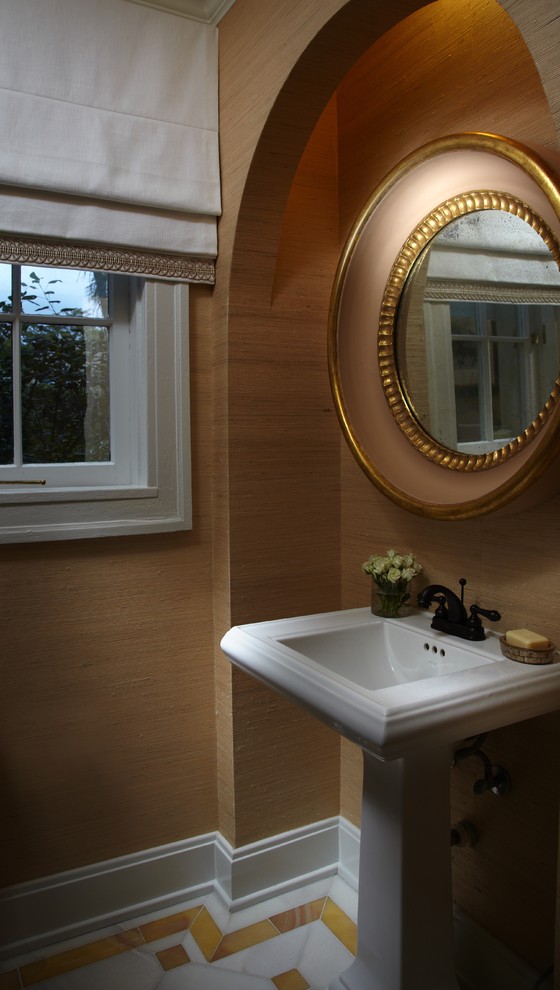 This is an example of a mid-sized asian powder room in Miami with a pedestal sink, a two-piece toilet, white tile, beige walls and marble floors.