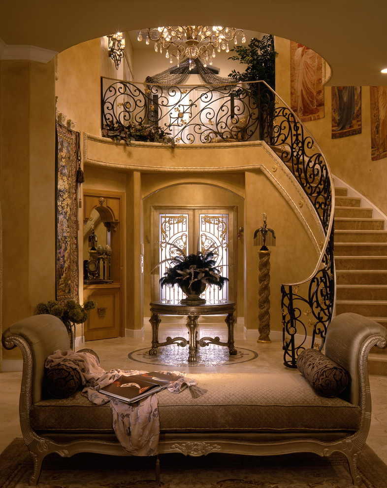 This is an example of a mid-sized mediterranean foyer in Miami with beige walls, marble floors, a double front door, a glass front door and beige floor.