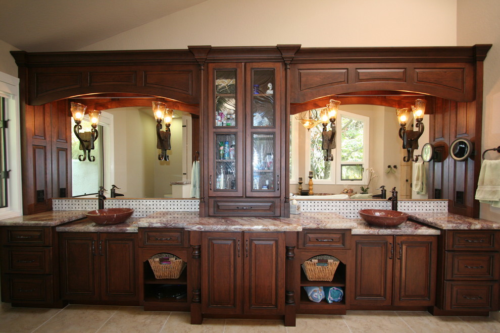 Large traditional master bathroom in San Francisco with a console sink, raised-panel cabinets, dark wood cabinets, marble benchtops, a corner shower, a one-piece toilet, beige tile, stone tile, beige walls and travertine floors.